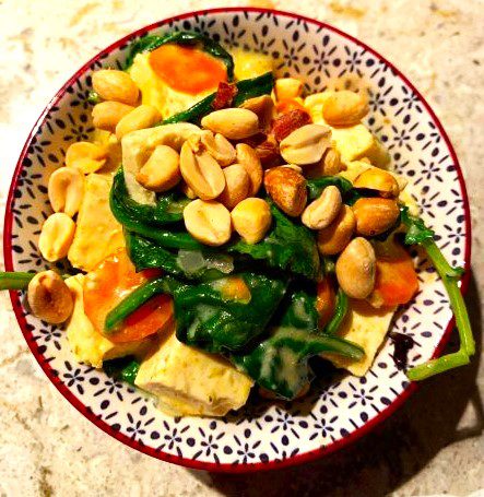 Tofu, spinach, and carrots in coconut curry sauce