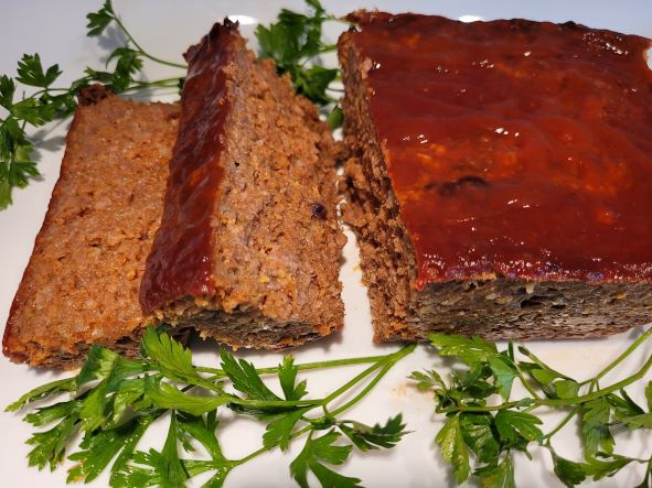A close up of two slices of meatloaf