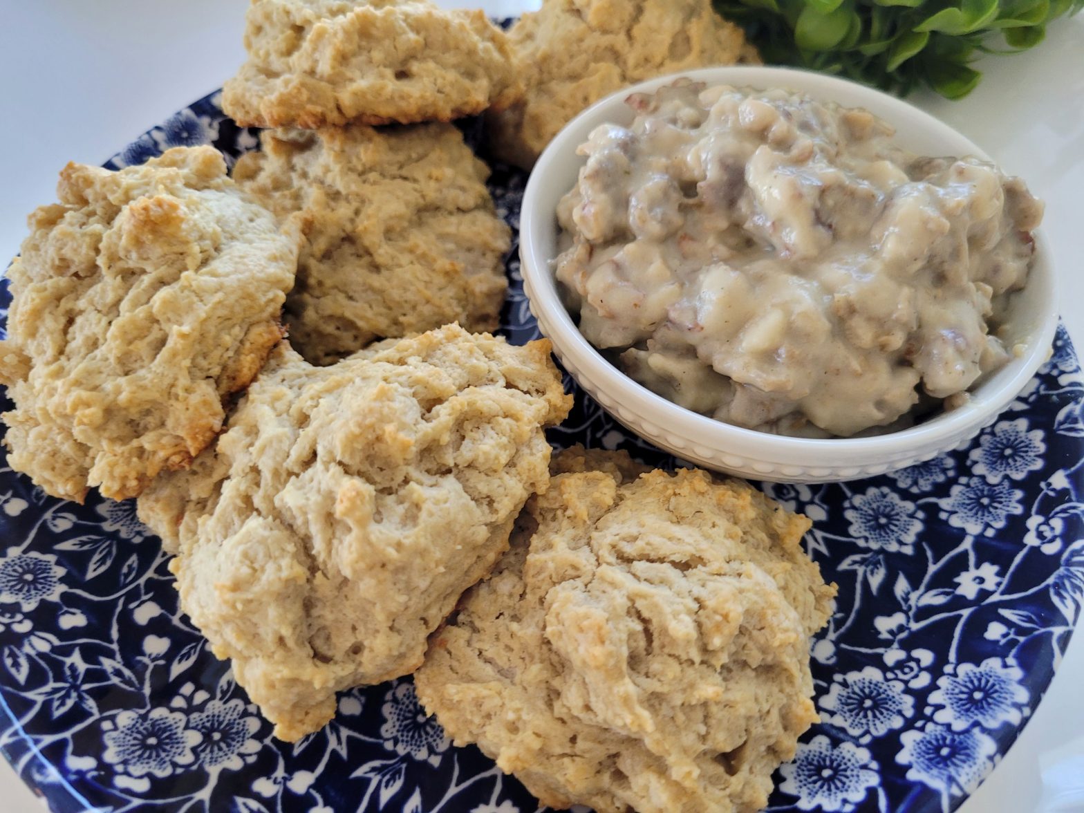 A plate of biscuits and gravy on the side.